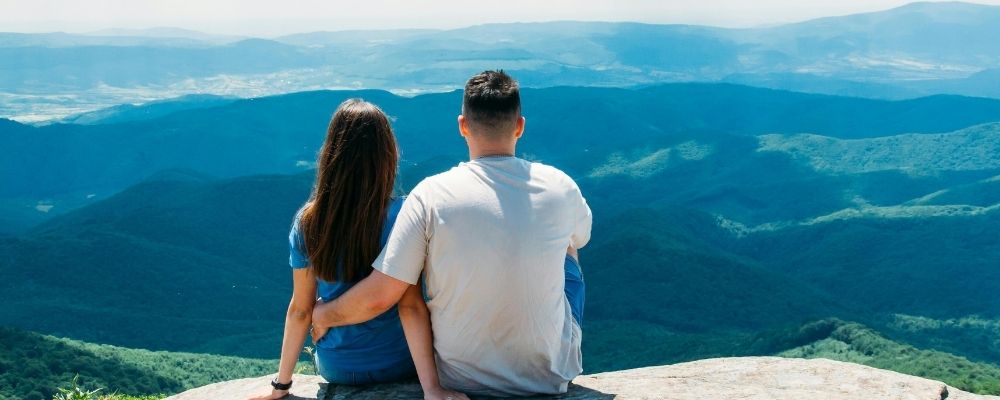 Romantic honeymoon couple enjoying scenic mountain views in Mussoorie